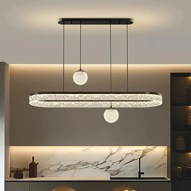 Modern oval-shaped crystal chandelier with spherical pendant lights, black metal frame, and clear faceted crystals for indoor use