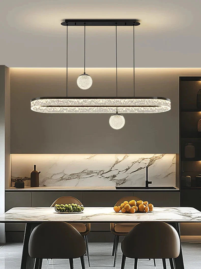 Modern oval pendant light with textured crystal design and black metal frame for living and dining room lighting