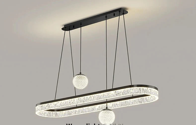 Modern black-framed oval pendant light with crystal rings and glass globes for living and dining room lighting