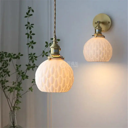 Antique brass-finished modern honeycomb ceramic led wall sconce with frosted glass globes for bedroom decorbites ceramic led lighting