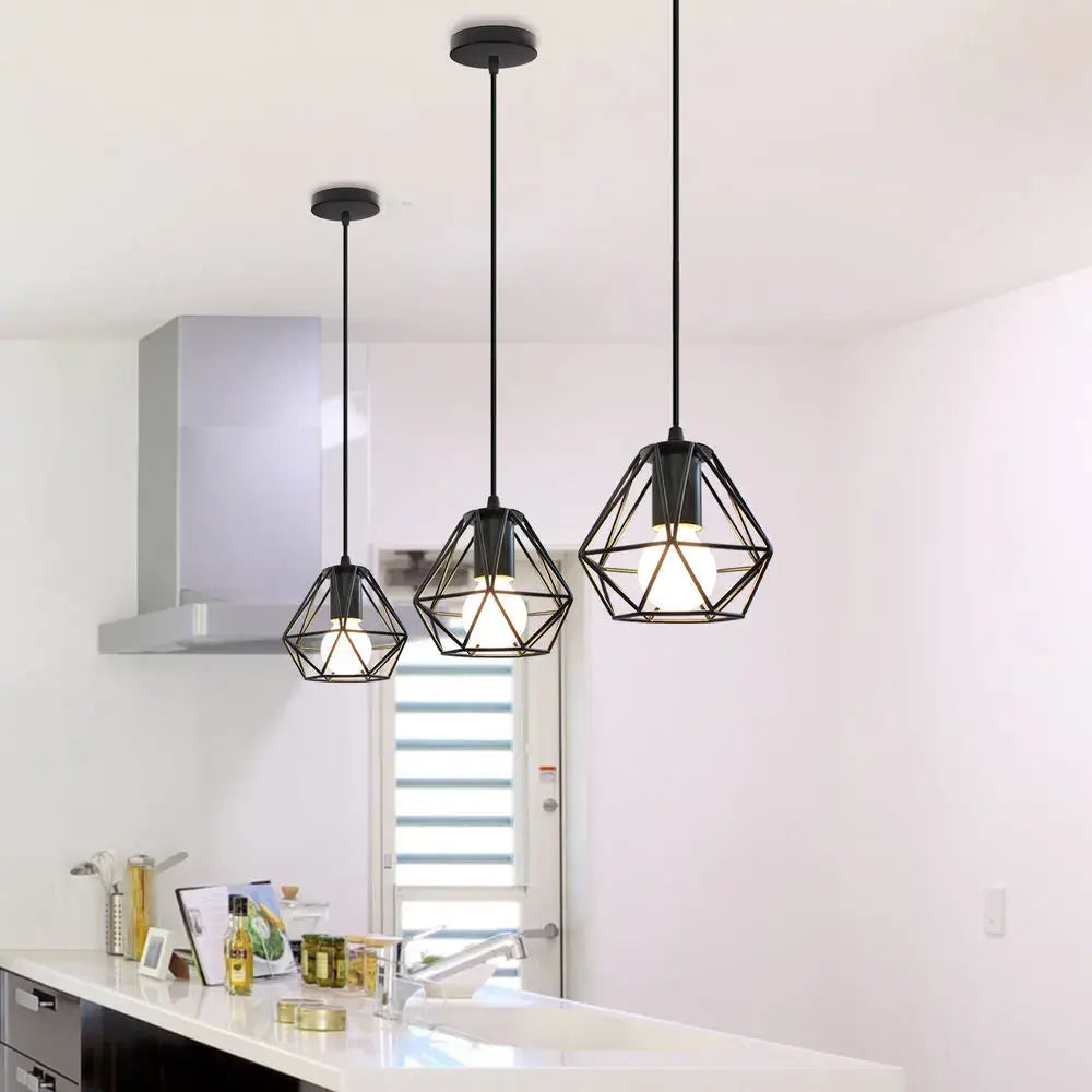 Three black geometric decorbites cage pendant lights with modern industrial design hang in dining room decor