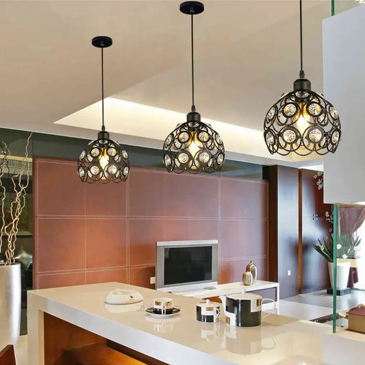 Three black wrought iron pendant lamps with crystal k9 accents hang above a modern kitchen island decorbites crystal pendant lamp