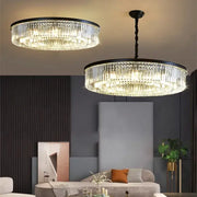 Two elegant decorbites crystal ceiling chandeliers with black metal frames and cascading clear glass prisms for dining room