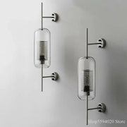 Modern industrial chrome glass wall lights with clear glass cylindrical shades and perforated metal inserts for living room decorbites glass industrial sconces