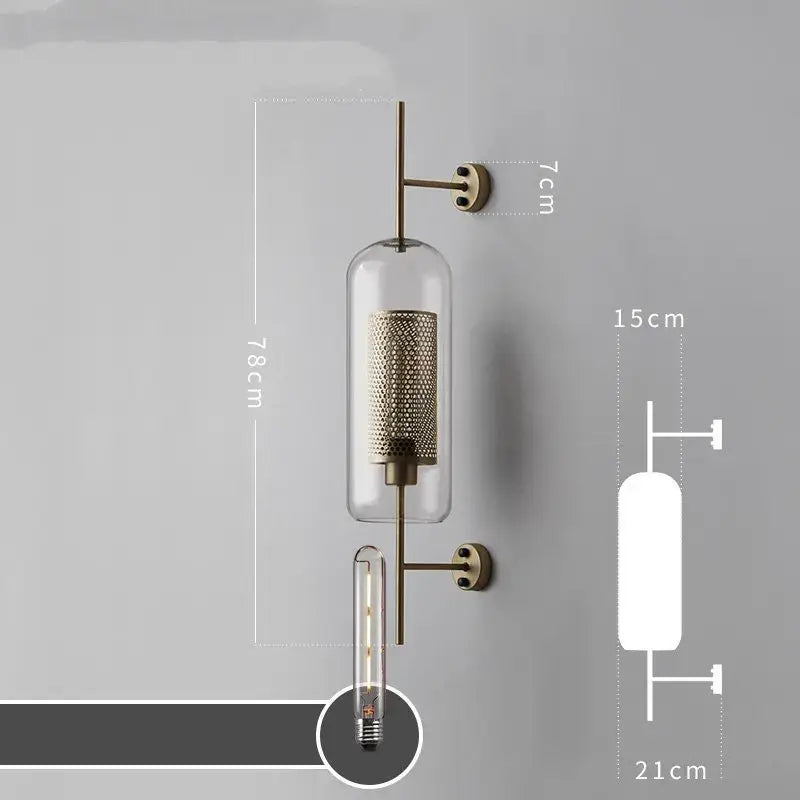 Modern industrial chrome glass wall sconce with brass finish clear glass cylinder and intricate mesh interior for wall lights decorbites glass industrial