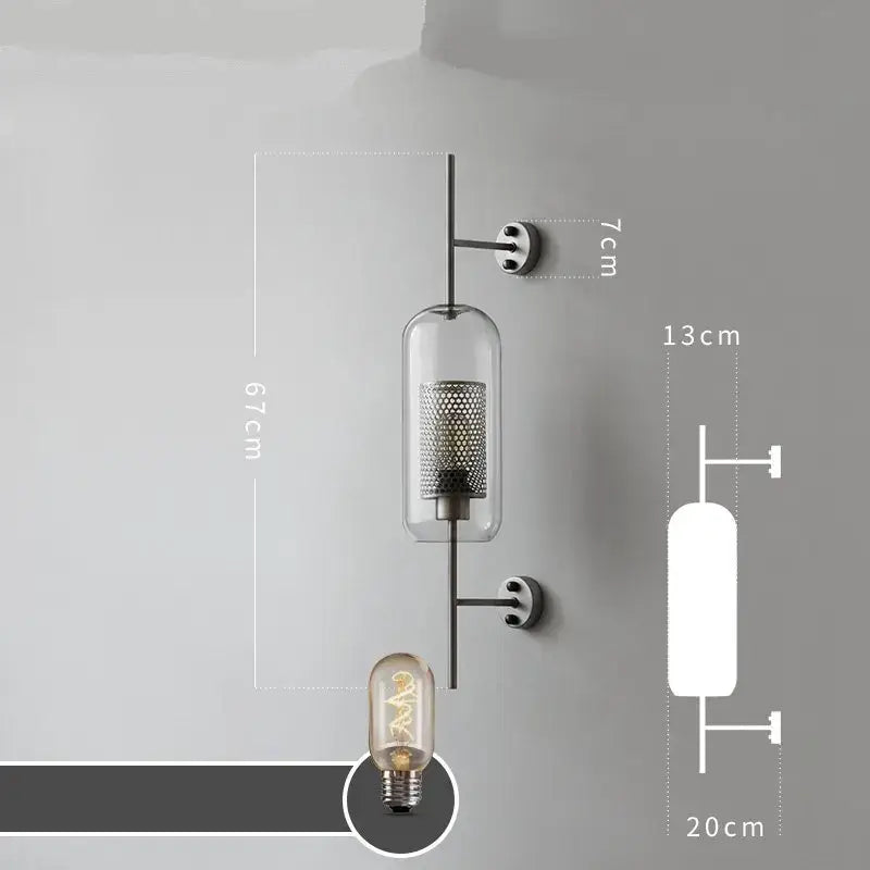 Modern industrial chrome glass wall lights featuring clear glass cylinders with metallic mesh on black metal arms