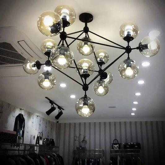 Modern industrial pendant light with multiple spherical glass bean bulbs on black metal frame for living room decorbites glass bean