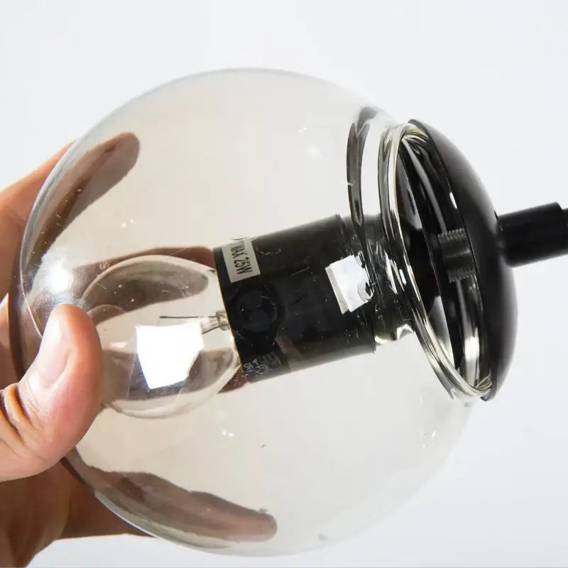 Modern industrial glass bean pendant light with clear glass globe and black metal base for living room decorbites glass bean