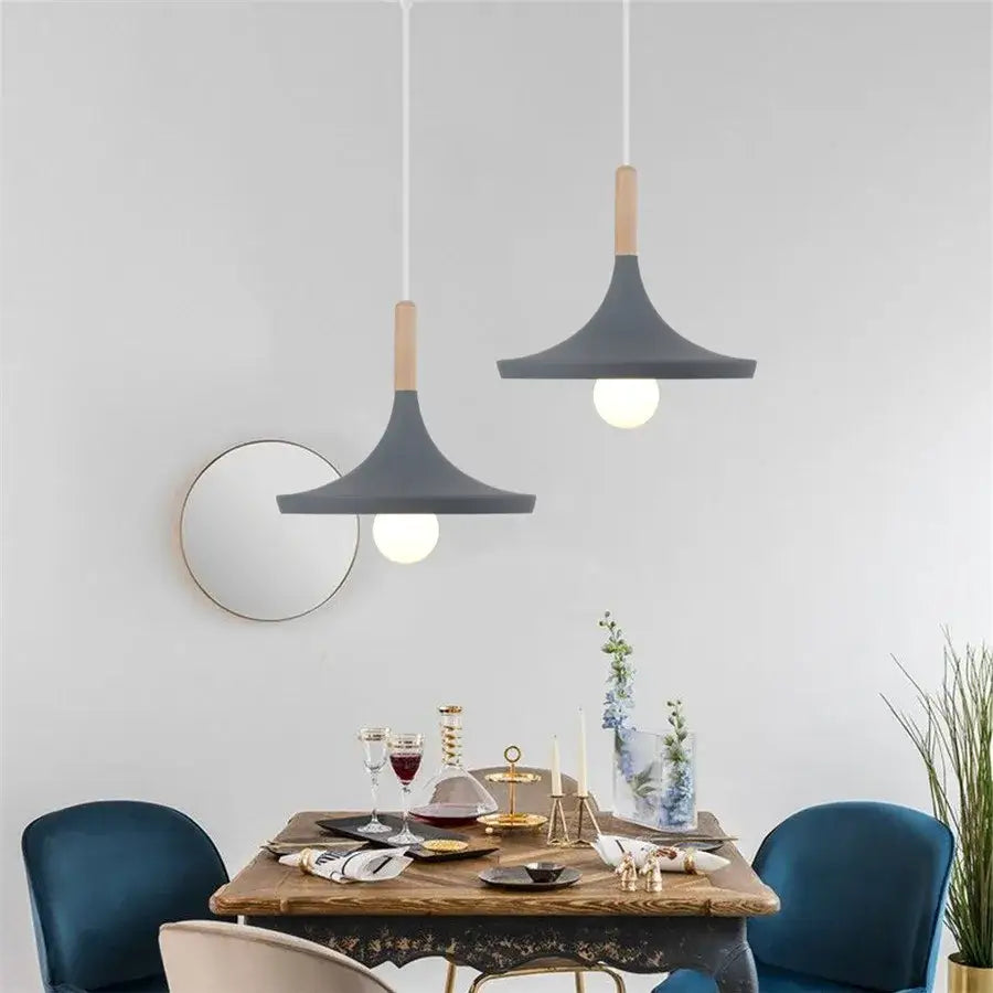 Modern industrial gray and black pendant light with wooden accents hanging above dining table decorbites industrial gray pendant