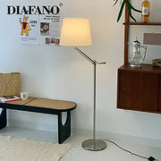A sleek modern industrial metallic decorbites adjustable led floor lamp with cream fabric shade for living room decor