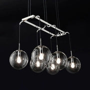 Modern chrome-finished pendant island lighting with five clear glass globe shades and smoke glass accents in nickel bronze