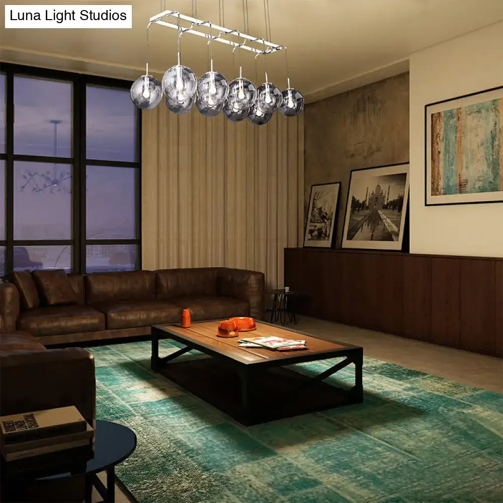 Modern chrome-finished chandelier with seven smoke glass globes for island lighting in nickel and bronze finish