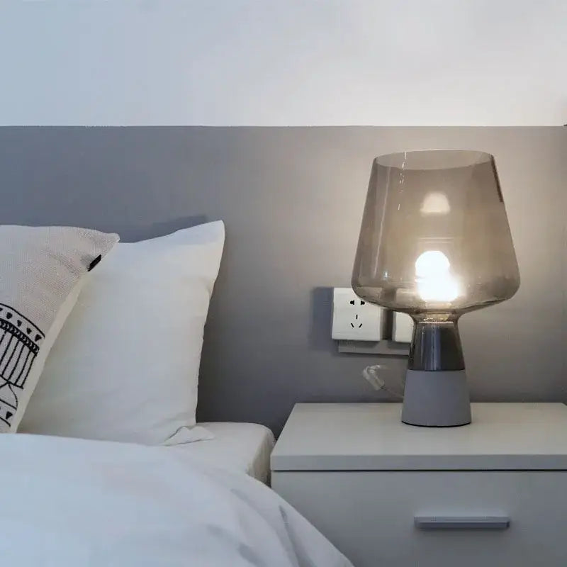 Modern industrial smoked glass and cement table lamp with translucent gray shade and metallic base by decorbites leimu cement