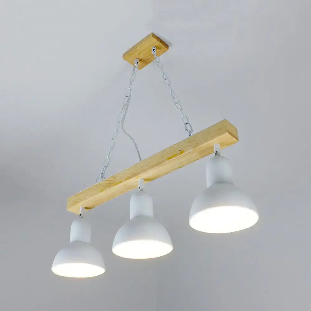 Modern farmhouse-style island light with natural wood beam and three white matte shades for dining table decor