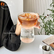 Clear glass drink cup with unique two-part design filled with iced coffee from modern insulated decorbites glass drink set