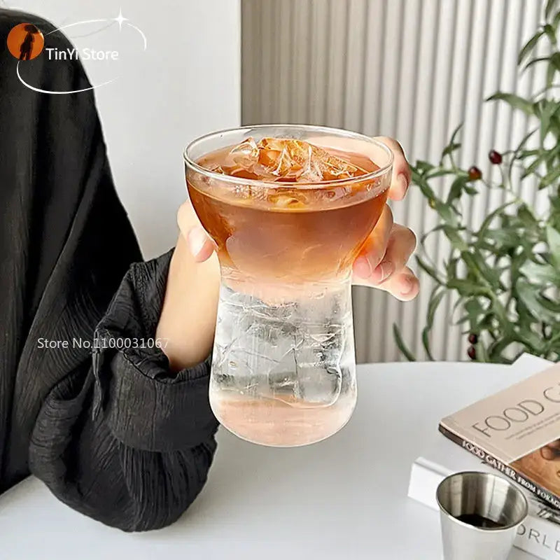 Clear glass drink cup with unique two-part design filled with iced coffee from modern insulated decorbites glass drink set