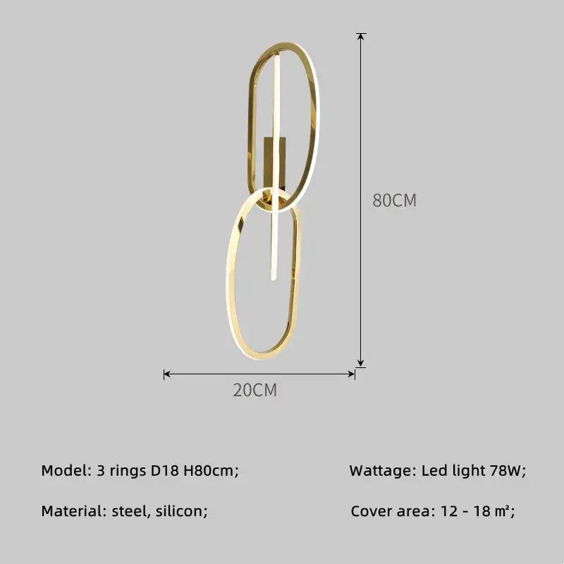 Gold-toned modern wall sconce lighting fixture with two interlocking oval rings and central led strip by decorbites gold led