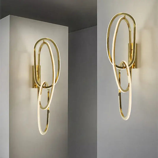 Modern interlocking oval gold wall sconce lighting fixture with decorbites gold led design for bedroom decor