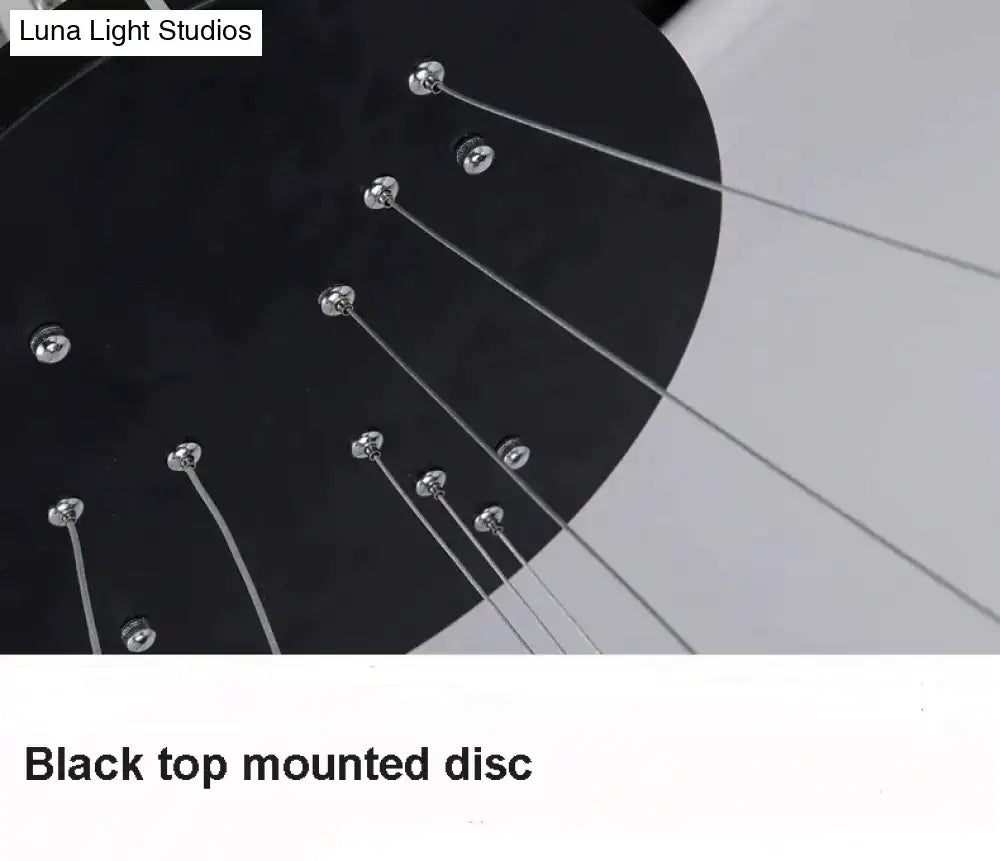 Black top-mounted disc with metallic screws and silver cables in modern pendant lights for dining room use