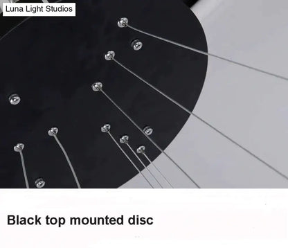Black top-mounted disc with metallic screws and silver cables in modern pendant lights for dining room use