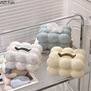 Three glossy ceramic tissue boxes in iridescent white blue and cream with a bubbly decorbites cotton candy design