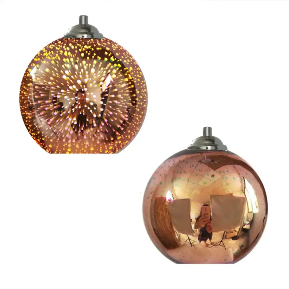 Two colorful 3d glass pendant lights with amber and rose gold finishes for modern dining room lighting
