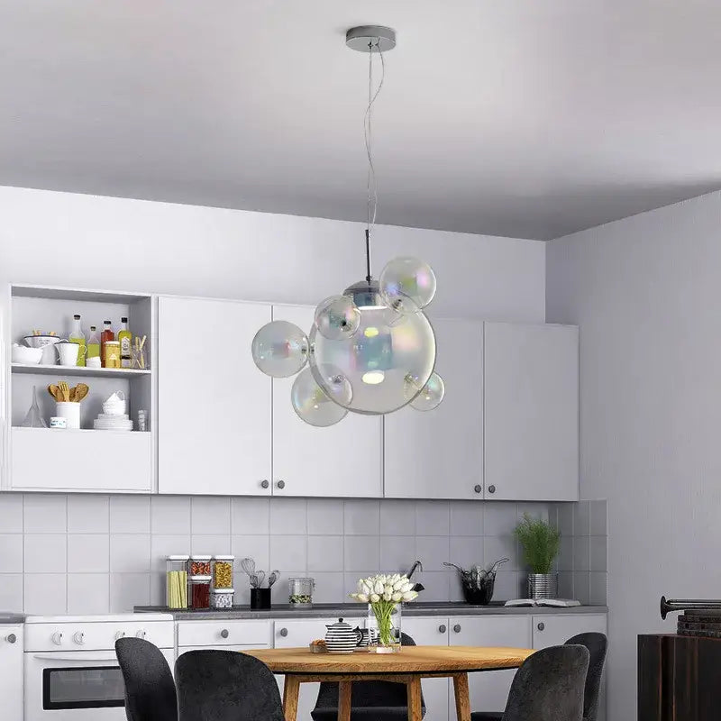 Modern iridescent colorful glass ball pendant light featuring multiple sized transparent glass spheres for dining room decorbites colorful glass design
