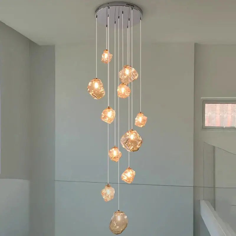 Modern iron and glass pendant light with amber glass globes and chrome fixture serving as a dining room statement piece