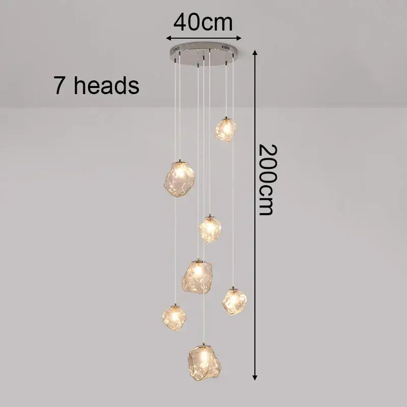 Modern 200cm pendant light with seven amber glass fixtures and chrome mount serving as a dining room statement piece