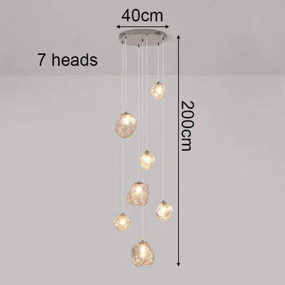 Modern 200cm pendant light with seven amber glass fixtures and chrome mount serving as a dining room statement piece