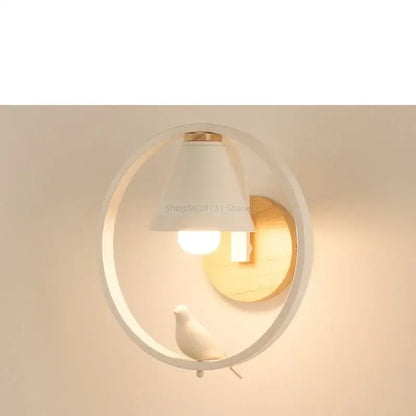 Modern iron led wall lamp with white circular sconce wooden backplate and small white bird figurine for bedroom decorbites iron led