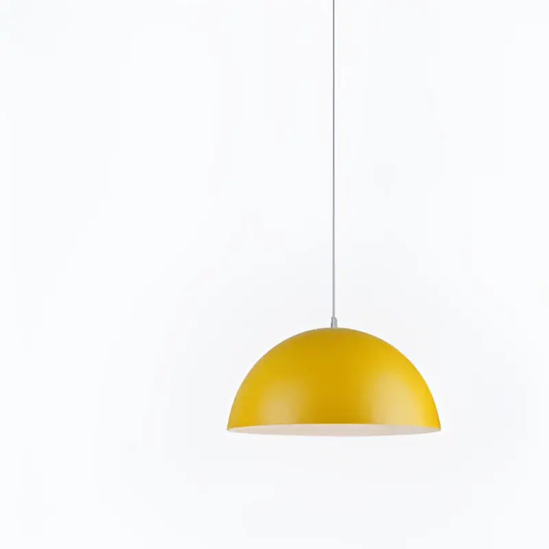 A sleek modern yellow iron lustre pendant light with smooth metallic finish and white interior for kitchen bar decorbites