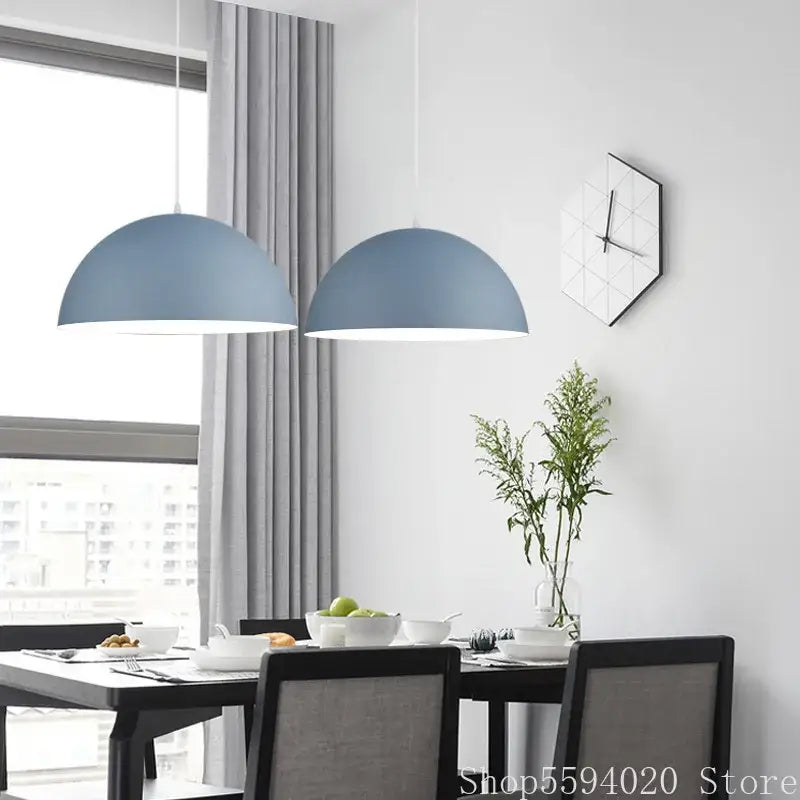 Two matte blue dome-shaped iron lustre pendant lights hang from the ceiling for modern kitchen decorbites pendant lights