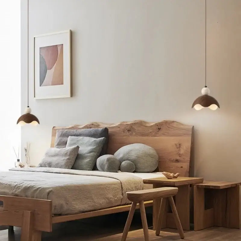A rustic wooden bed with live-edge headboard and matching nightstands under decorbites iron yellow travertine pendant light