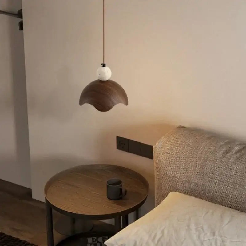 Minimalist pendant light with dark wood petal shade and white spherical top for modern iron yellow travertine decorbites