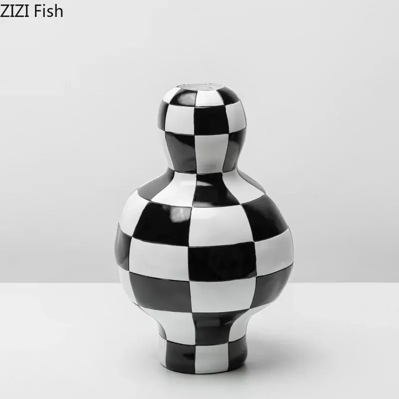 A glossy black and white check ceramic vase with a rounded body and narrow neck for modern room decor decorbites black white