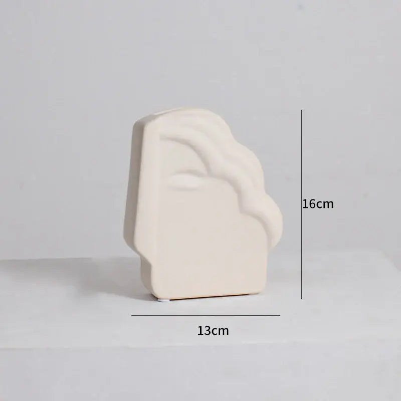 Cream-colored ceramic bookend with smooth abstract face design for modern irregular ceramic vase decorbites irregular ceramic