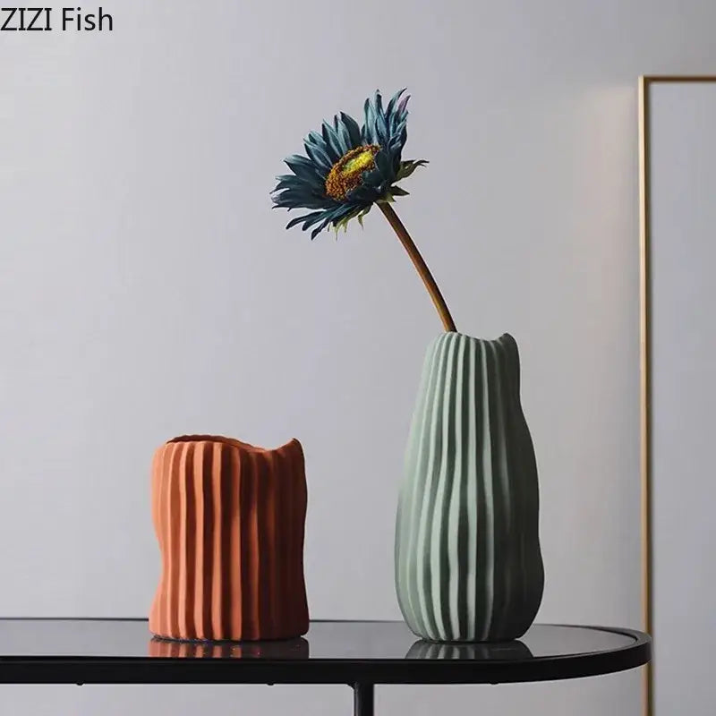 A sleek sage green ribbed irregular ceramic vase from decorbites perfect for modern living room decor