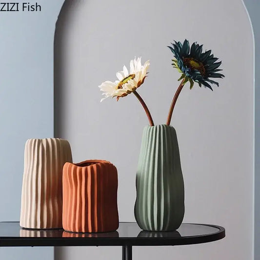 Modern irregular ceramic vase trio in beige terracotta and sage green with vertical ribbed texture by decorbites irregular ceramic