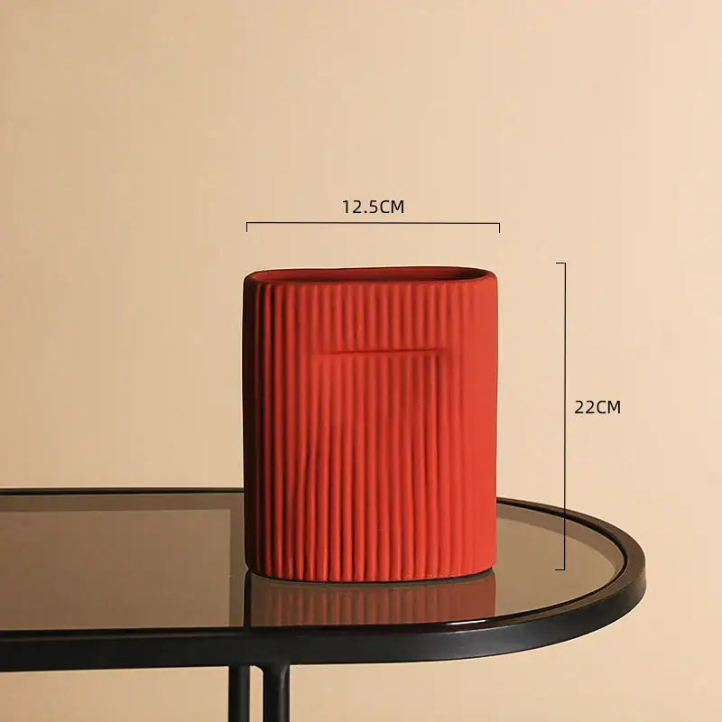 Vibrant red irregular ceramic vase with vertical ribbed texture and rectangular top opening for modern decorbites decor