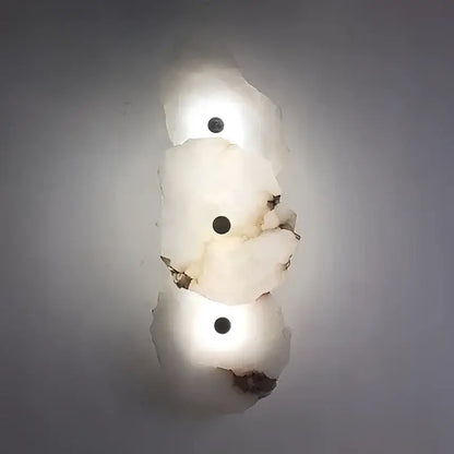 Modern ivory white marble led ceiling light features a white irregular stone with three dark circular inlays decorbites ivory white