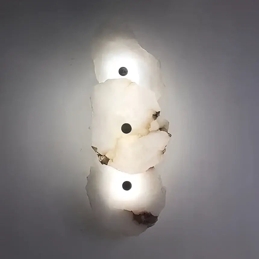 Modern ivory white marble led ceiling light features a white irregular stone with three dark circular inlays decorbites ivory white