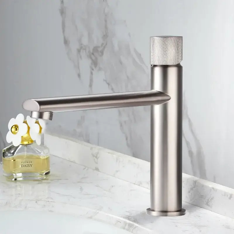 Modern knurled brushed gold basin faucet with a single-handle brushed stainless steel body and textured diamond knob by decorbites