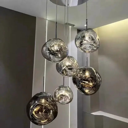 Modern lava glass pendant light set with frosted iridescent globes and polished chrome finish for dining rooms