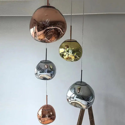 Set of five spherical glass pendant lights in copper gold and silver finishes with polished chrome finish for dining room