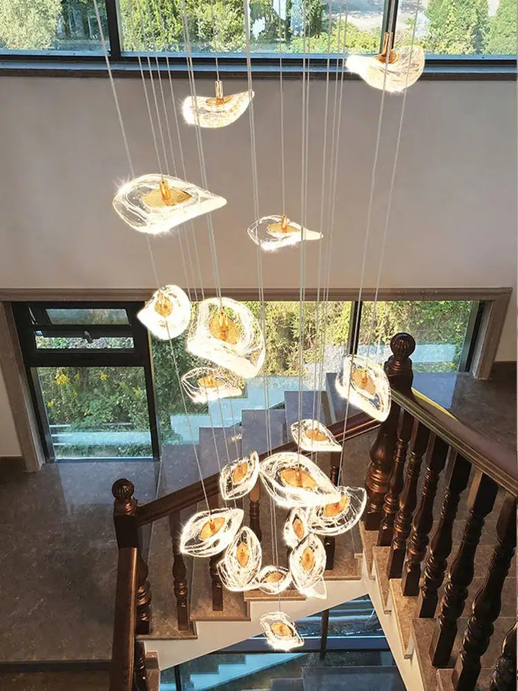 A modern leaf crystal glass staircase chandelier with multiple translucent shell-shaped pendants for living room decorbites crystal glass lighting