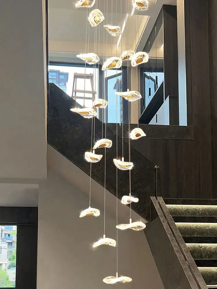 A modern leaf crystal glass staircase chandelier with translucent shell-shaped light fixtures for living room decorbites