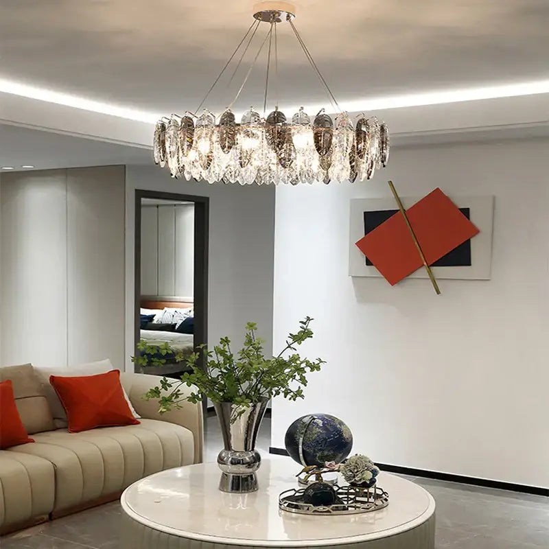 A modern pendant light with gold silver crystal leaf design featuring layered clear crystals for living room decorbites