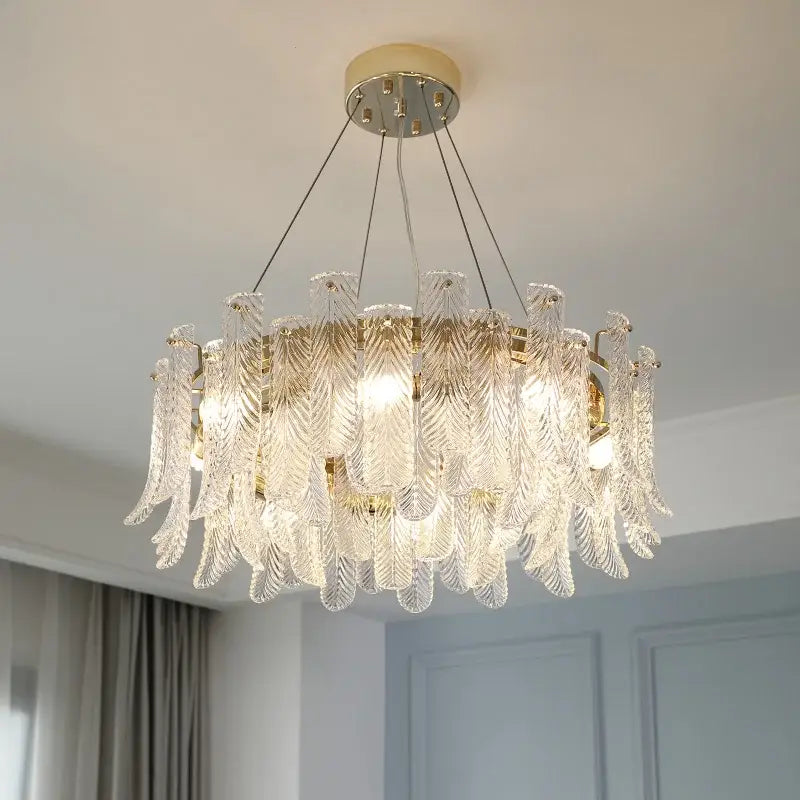 A modern leaf textured glass crystal led ceiling lamp with feather-shaped clear glass and gold-toned metal decorbites crystal led