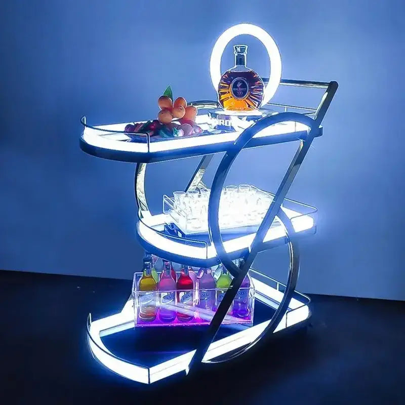 A sleek modern three-tiered chrome beauty salon trolley with glowing led lighting for salon storage and use